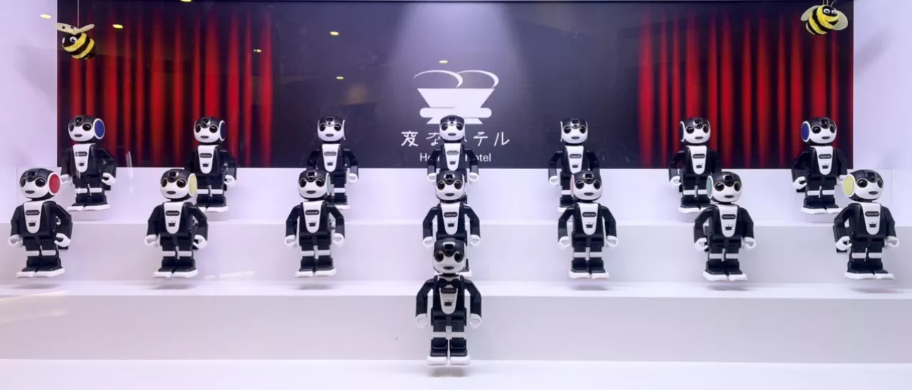 Fifteen of Sharp’s “Robohon" welcoming customers with a song at Henna na Hotel