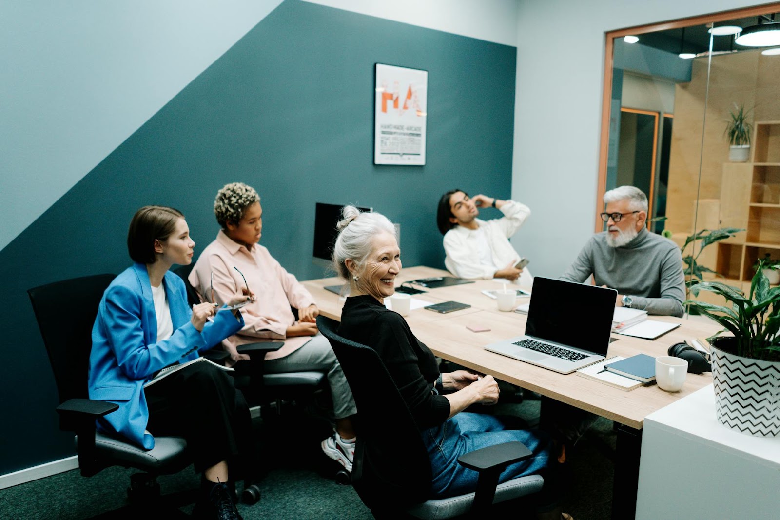 https://www.pexels.com/photo/woman-in-blue-long-sleeve-shirt-sitting-on-black-office-rolling-chair-5990031/