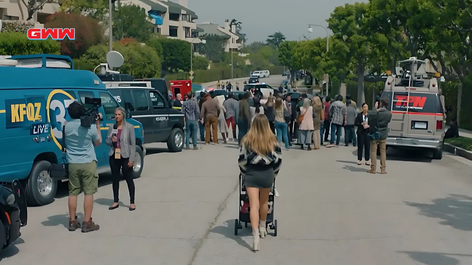 Morgan pushing a stroller with her child toward a crime scene