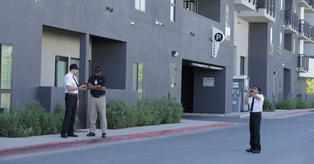 (Citiguard security officers conduct a routine patrol around a residential or mixed-use building—demonstrating coordination, surveillance, and property protection.)