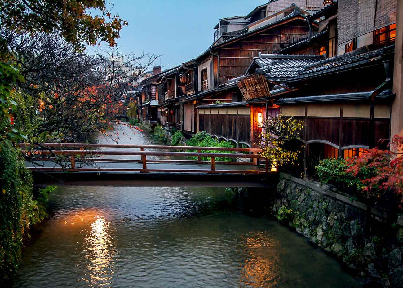 Shirakawa Canal in Gion district Kyoto at night with traditional buildings reflecting in calm water creating romantic atmosphere for kimono photography