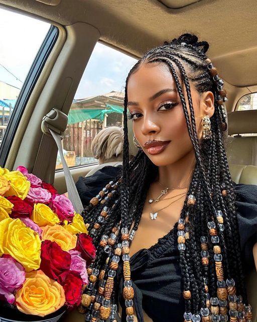 a lady rocking fulani braids with beads