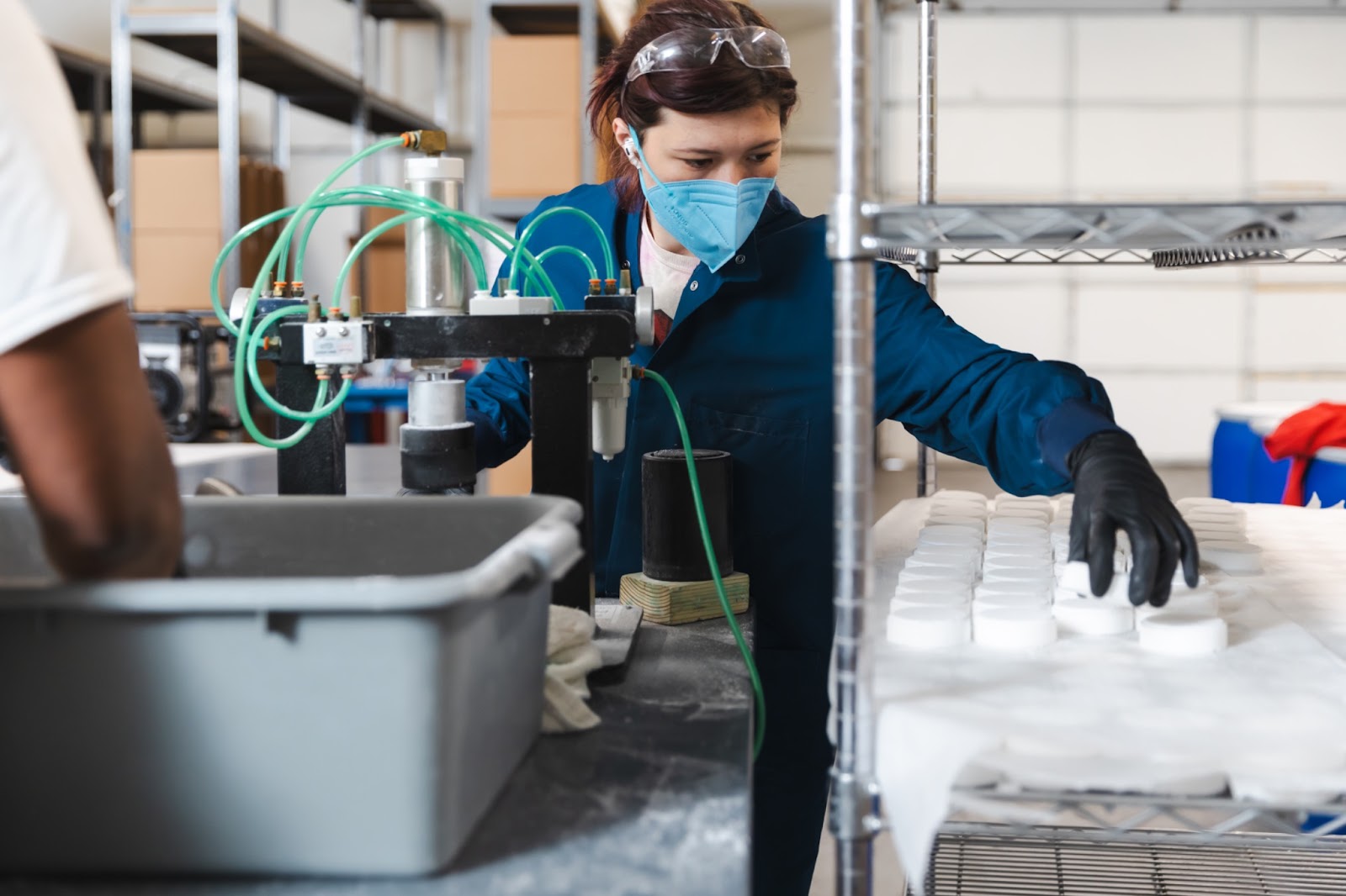 OWC production employee Tori moving a freshly pressed steamer to the drying rack