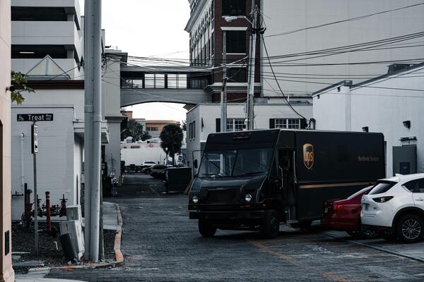 UPS delivery van parked on a street, representing reliable parcel shipping and logistics services.