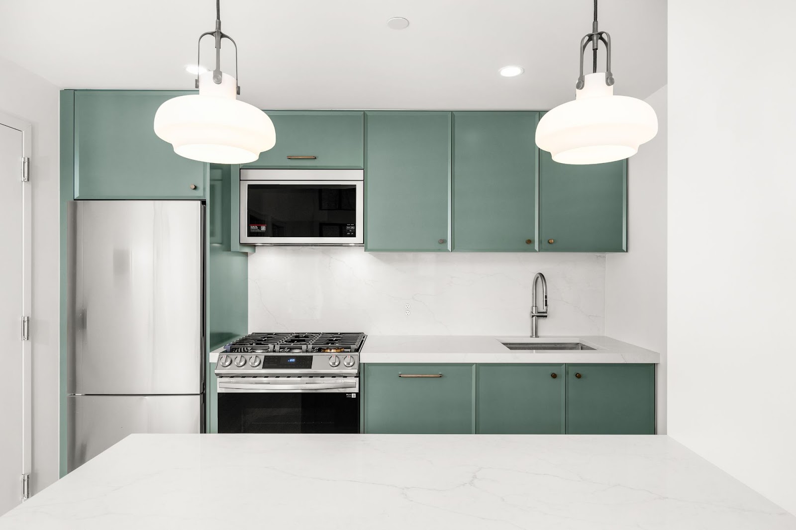 Clean kitchen renovation with turquoise cabinetry. 