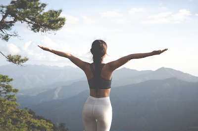 A woman performing a yoga pose, demonstrating flexibility and balance.