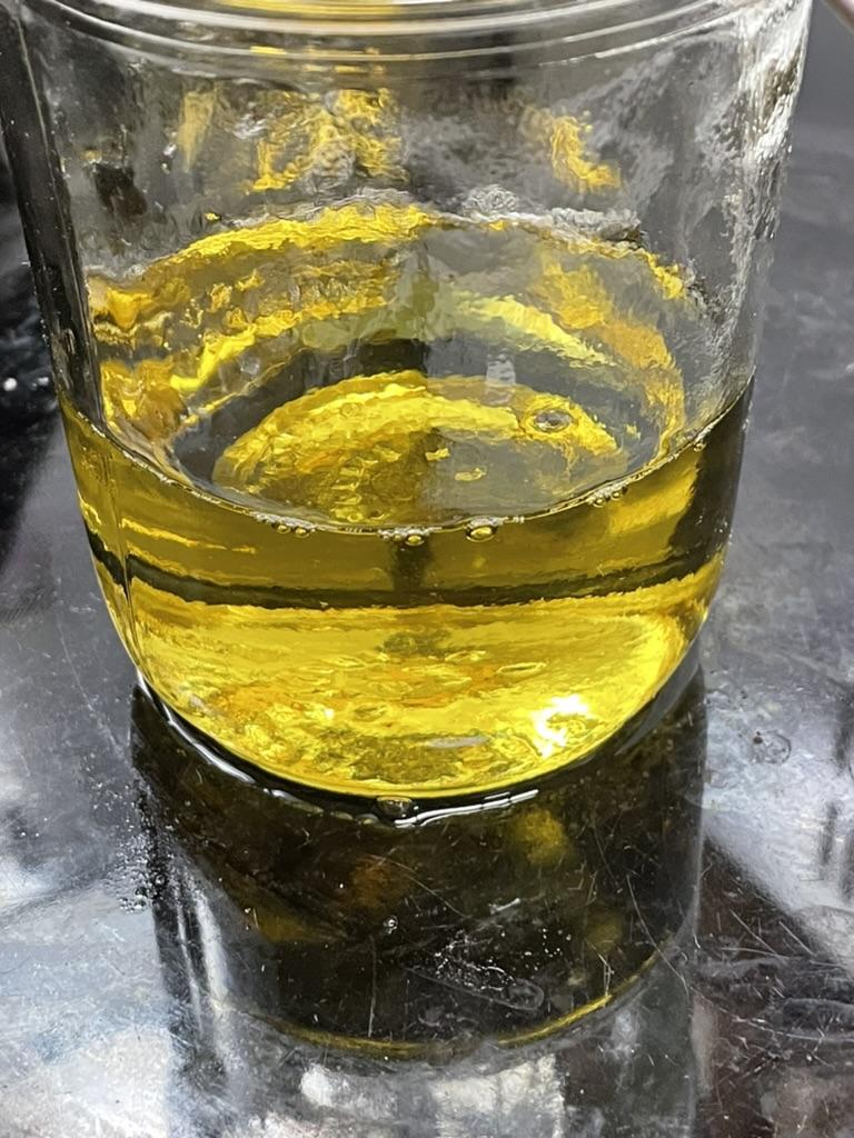 A glass with yellow liquid

AI-generated content may be incorrect.
