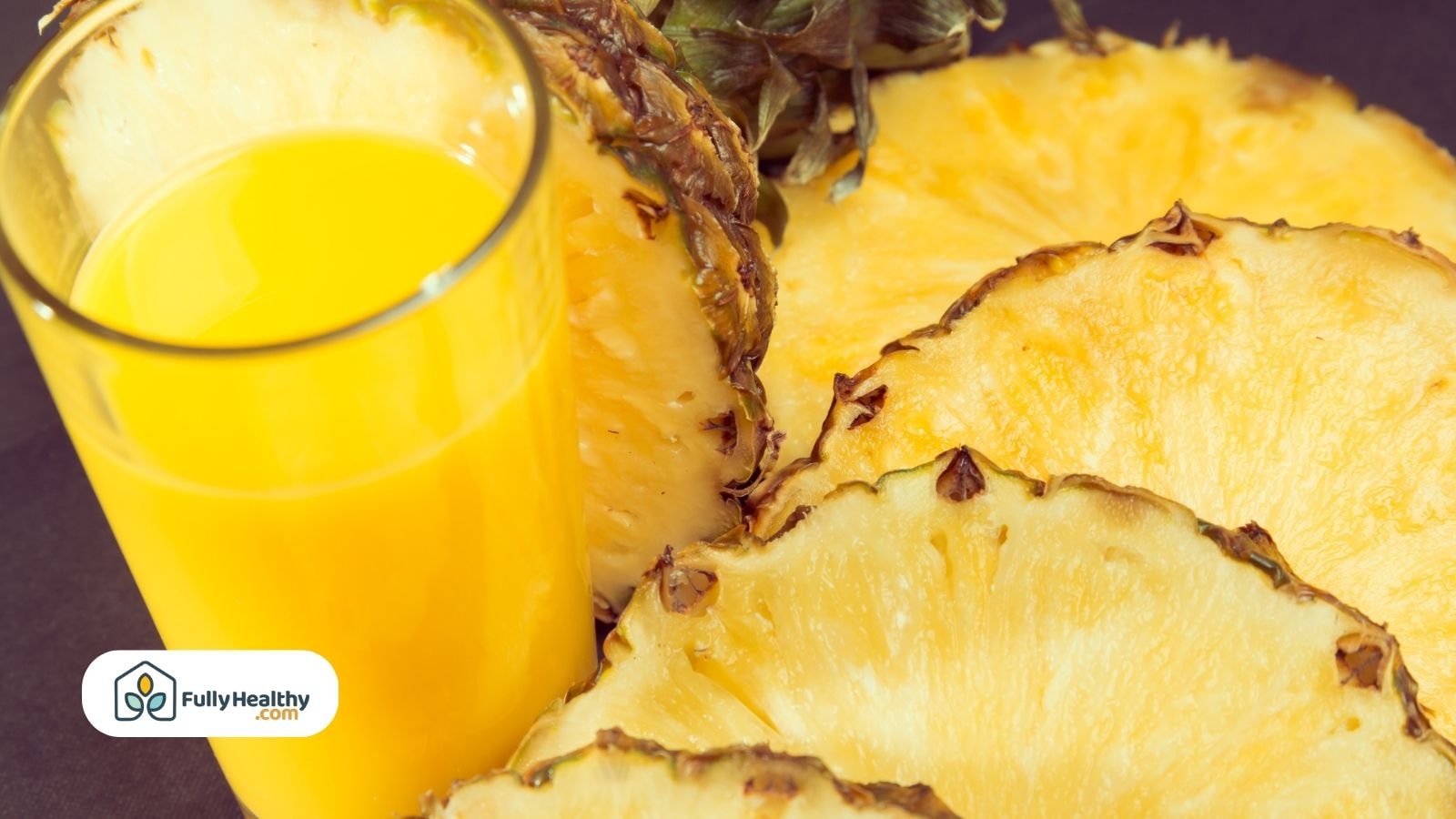 Close-up of pineapple slices and a glass of its juice