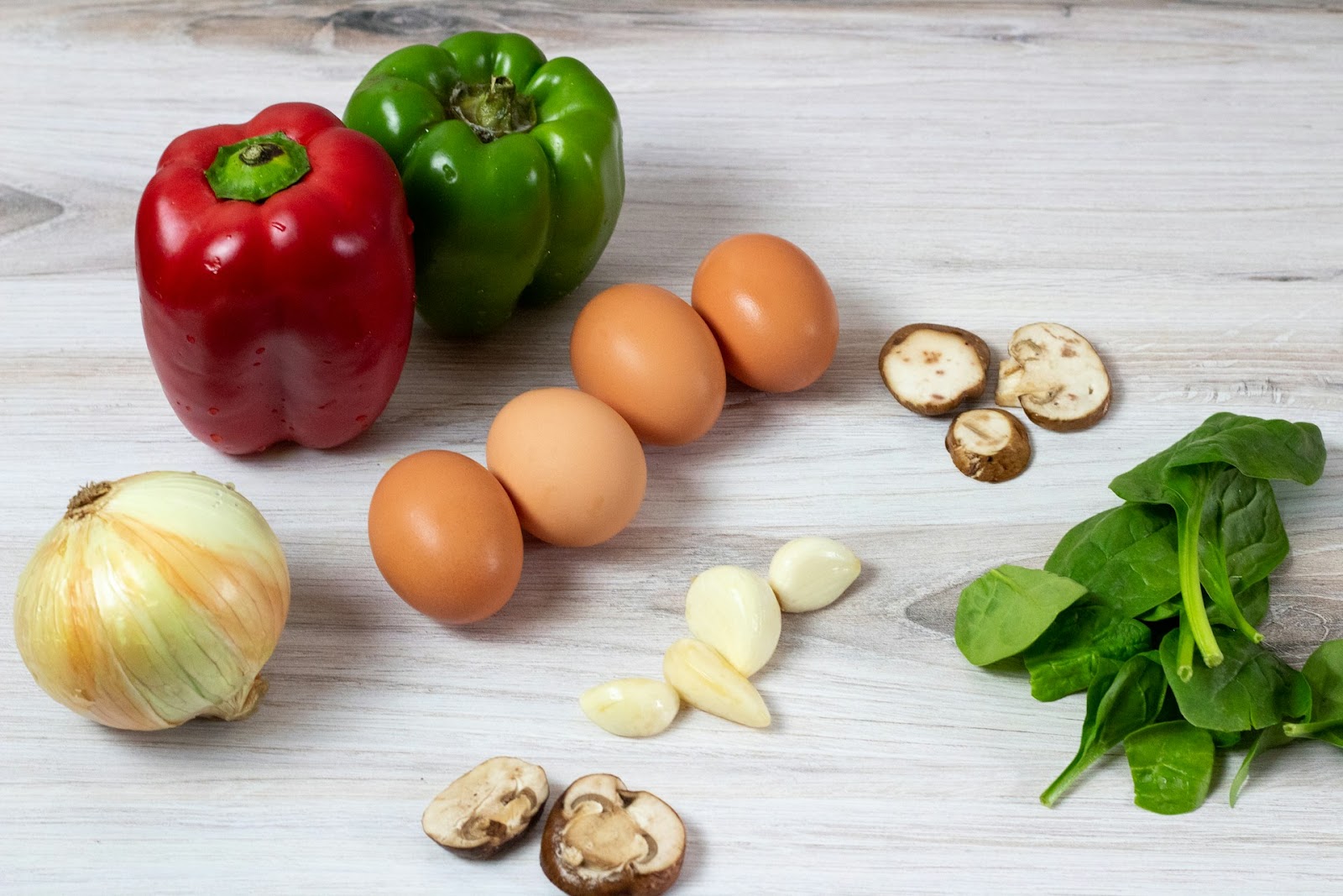 A bunch of vegetables on a while surface.