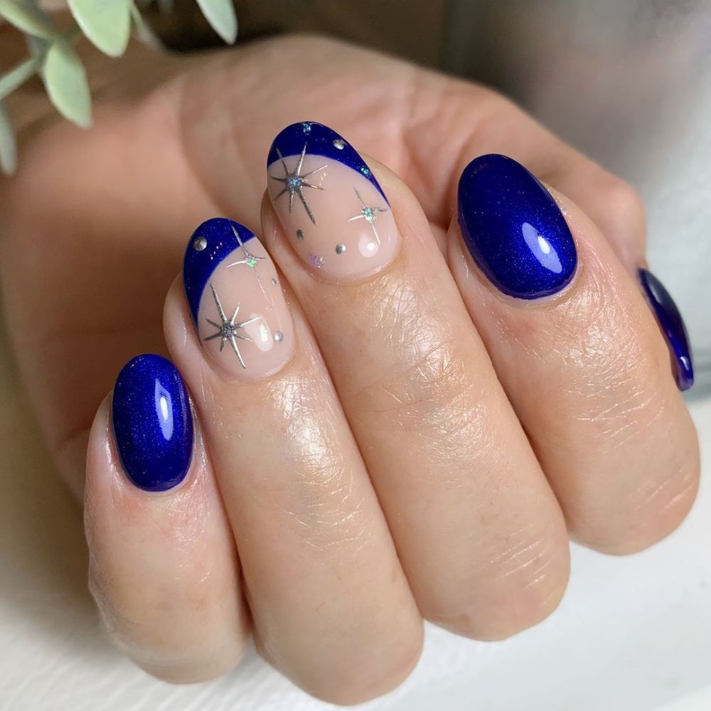 Close up of hands with blue winter nails having Short Winter Nail art