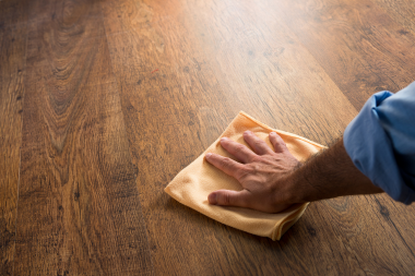 hardwood vs luxury vinyl flooring comparing interior upgrades cleaning floorboards with rag custom built michigan