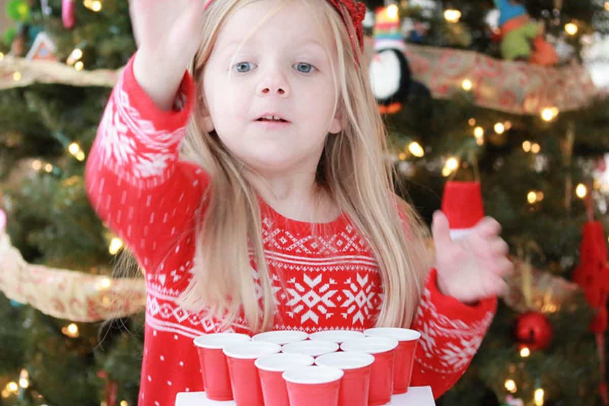 Girl playing Jingle Bell Toss game.