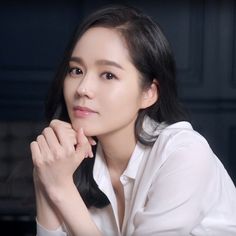 This contain an image of Han Ga wearing white shirt putting her hand on her chin