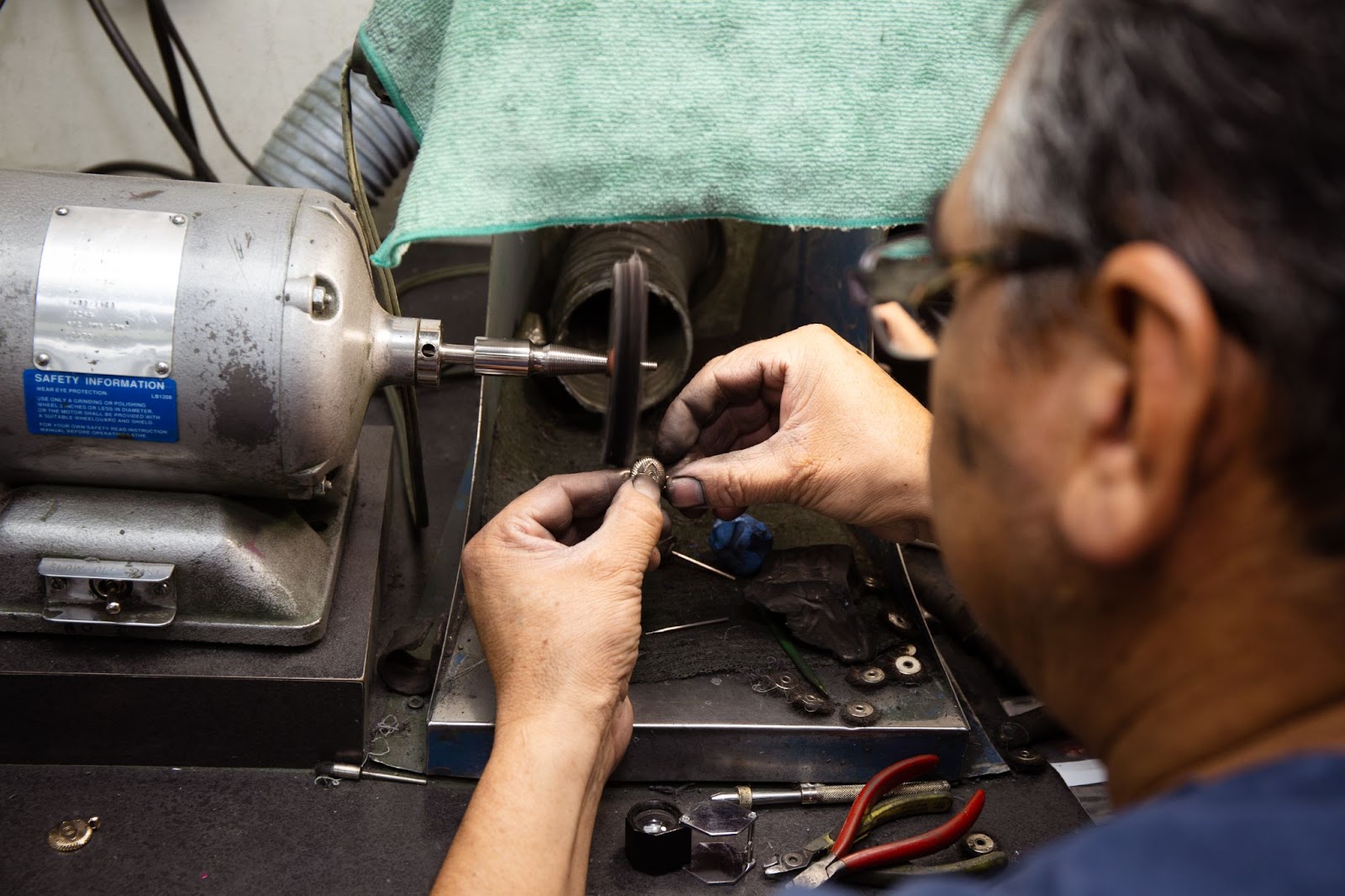 Jeweler polishing a custom ring.