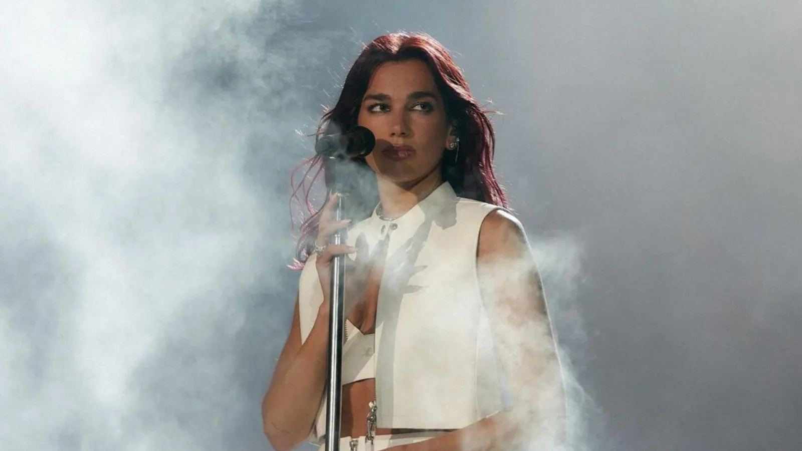 Dua Lipa on Stage before the mic in White Dress 