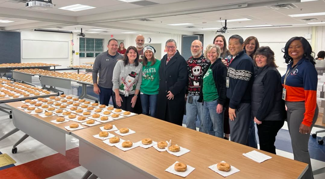 Dr. Reid with a group of staff members from West Springfield High School with lots of donuts on Donut Day.