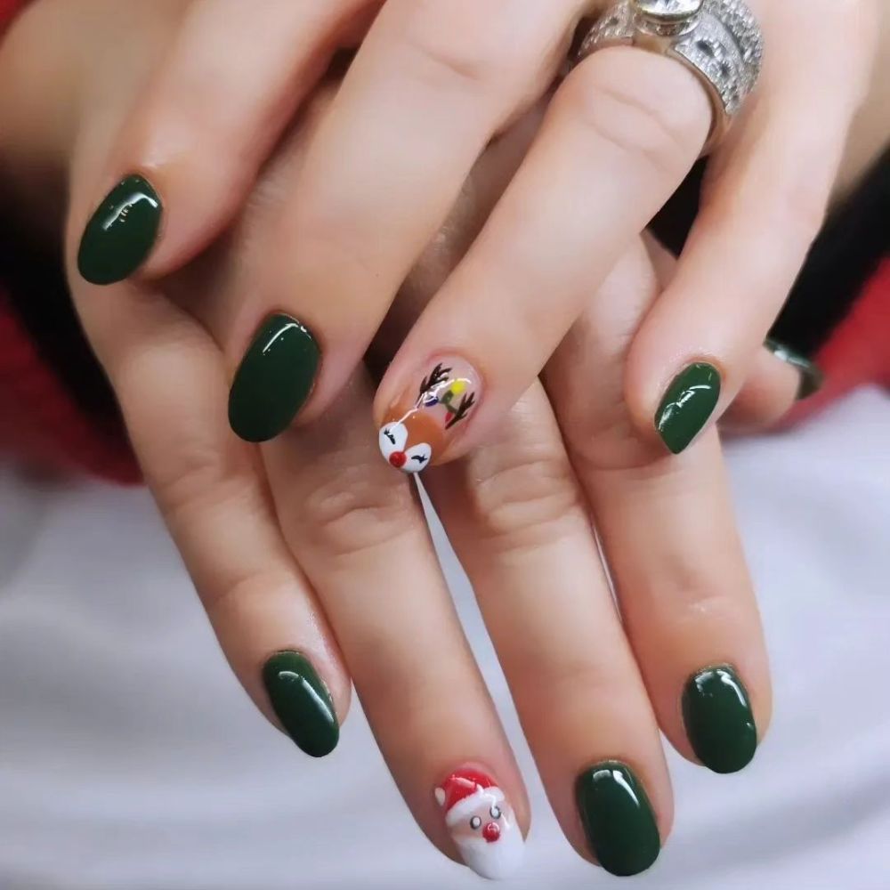 Close up of hands with Christmas Green Nails having  Festive Reindeer Face