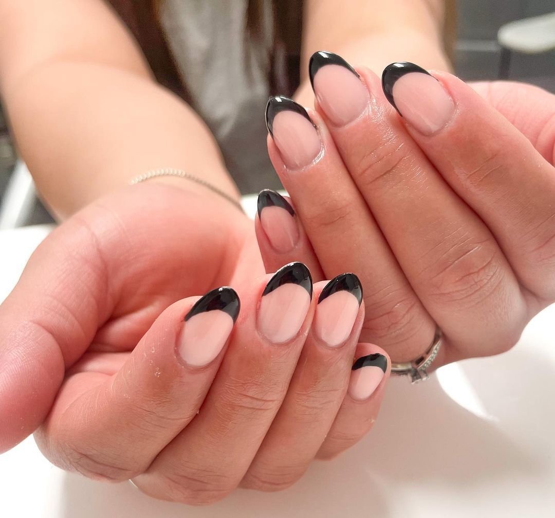 Close-up of a person's hands with black nails in Traditional Design