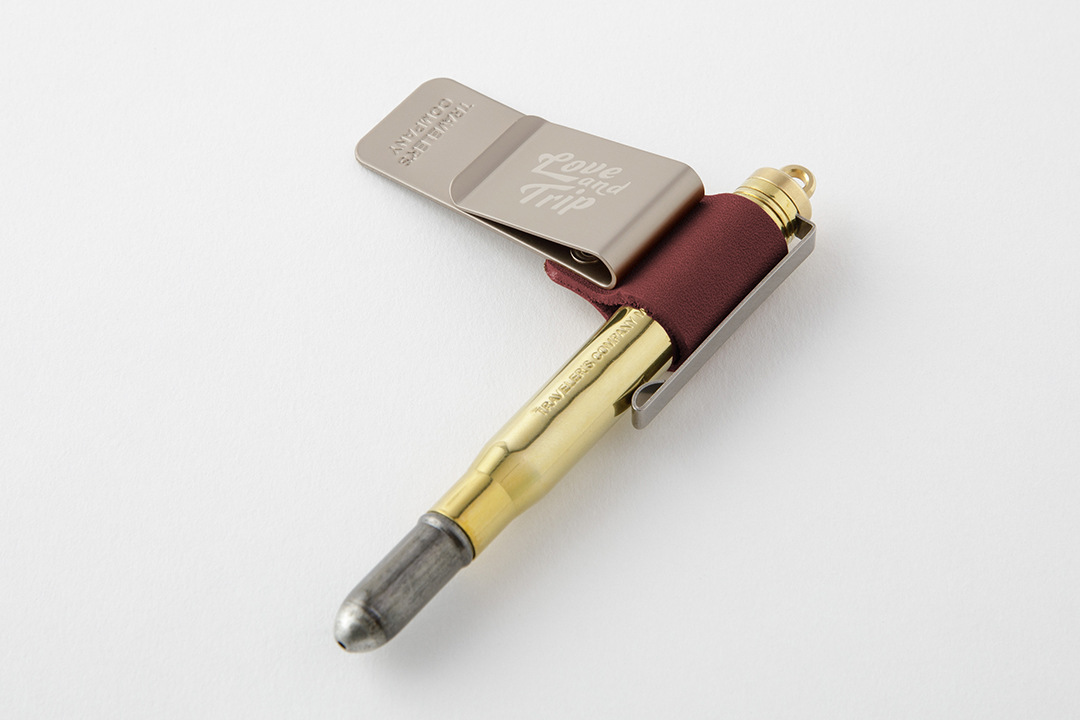 TRAVELER'S notebook Pen Holder LOVE AND TRIP Red with a brass pen.