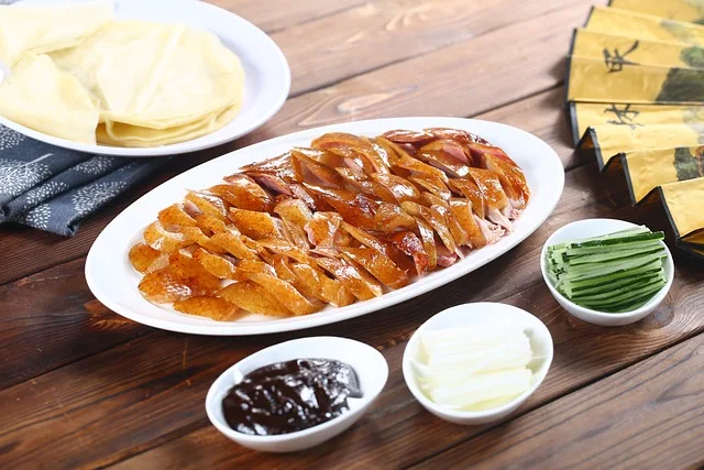 peking duck in a dish with herbs and sauces