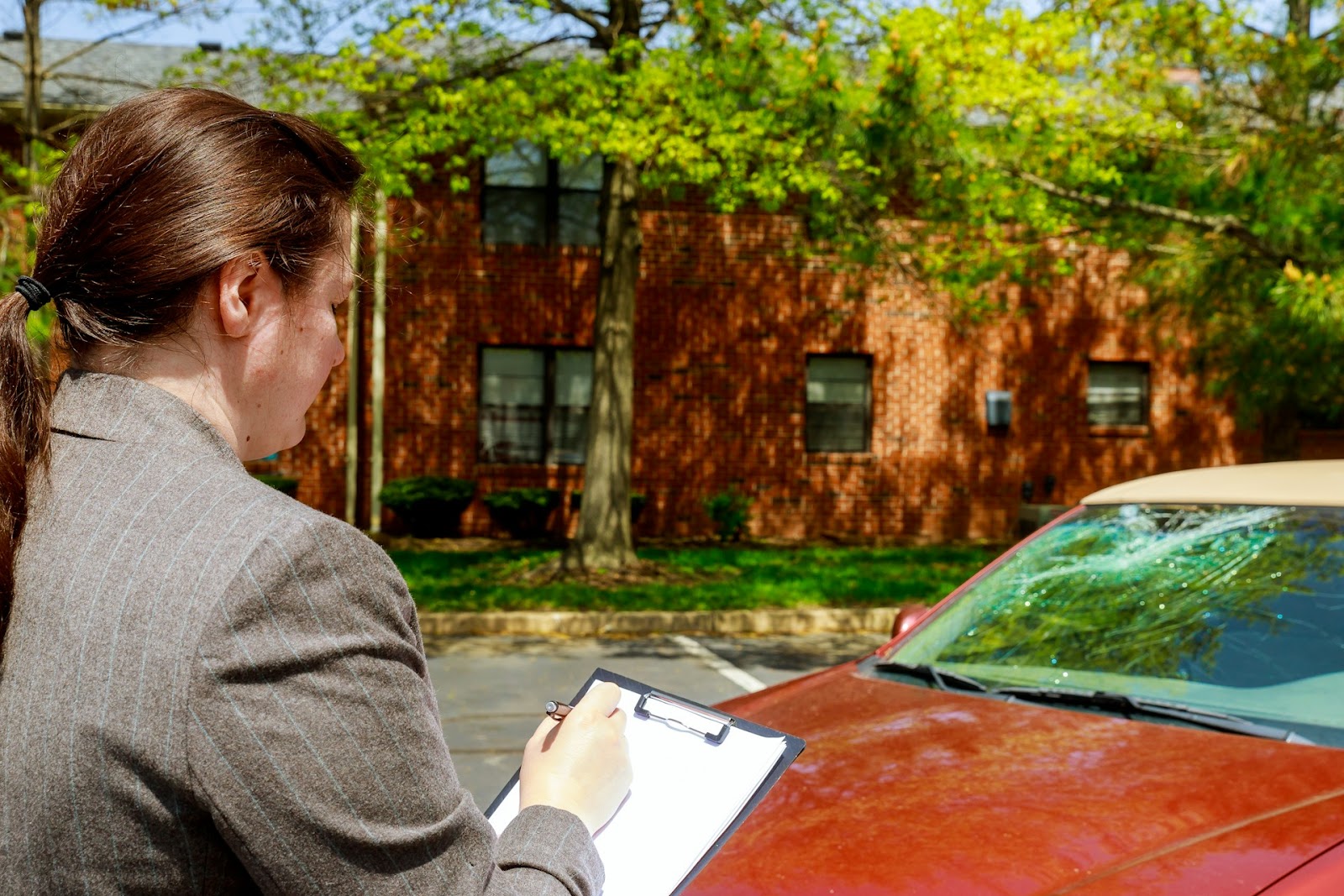 a woman checking a car after an accident