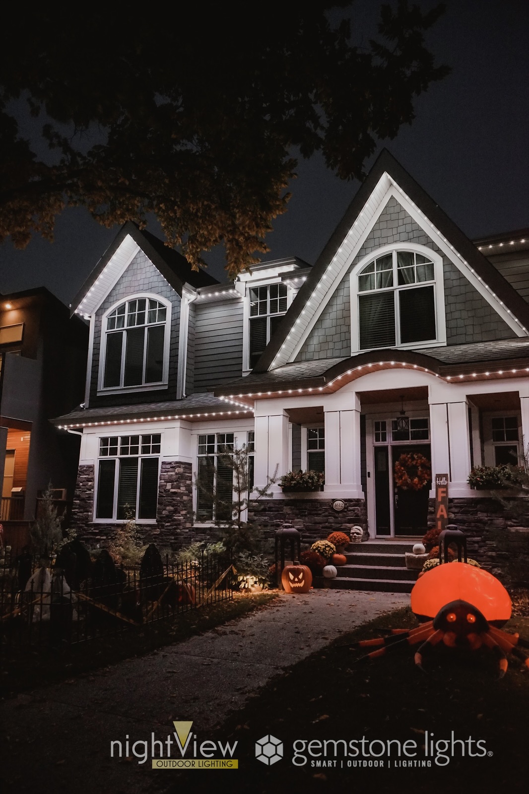 Permanent holiday lighting adds charm to this house decorated for Halloween