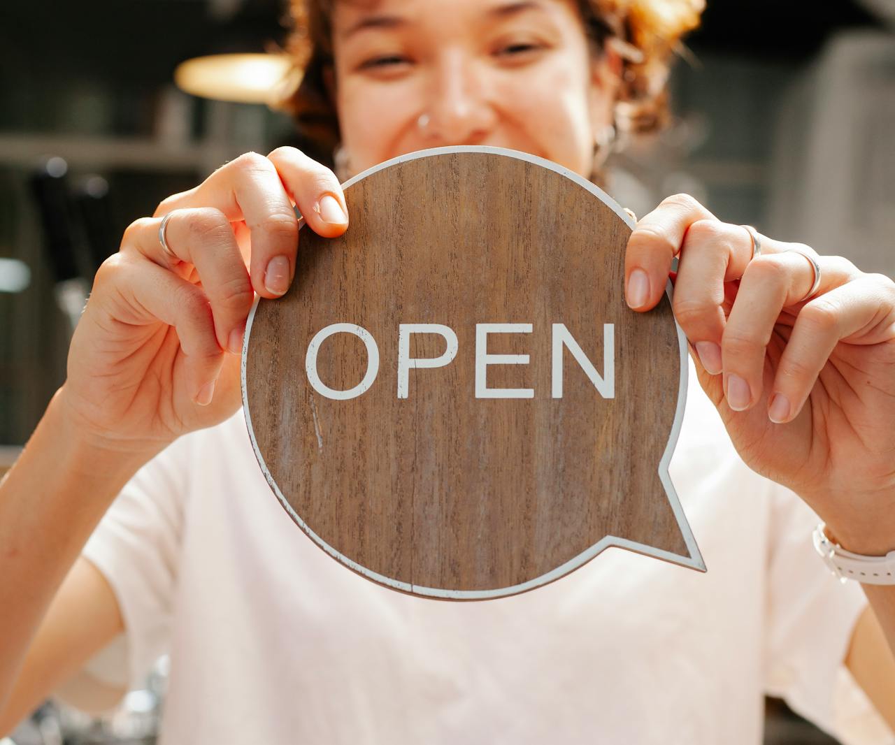 Women holding an open sign