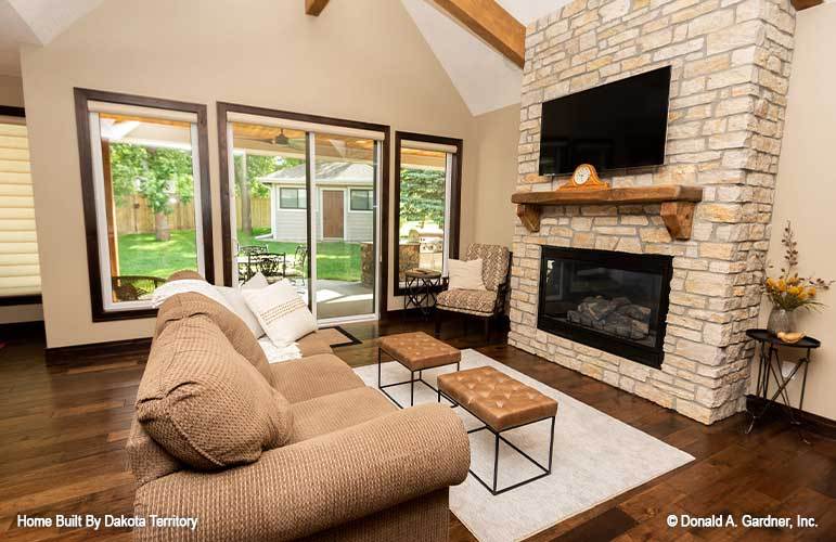 Sliding doors on the left side extend the living space onto the rear covered porch.
