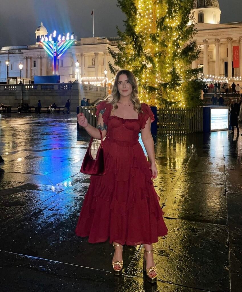 A woman wearing a red ruffle dress.