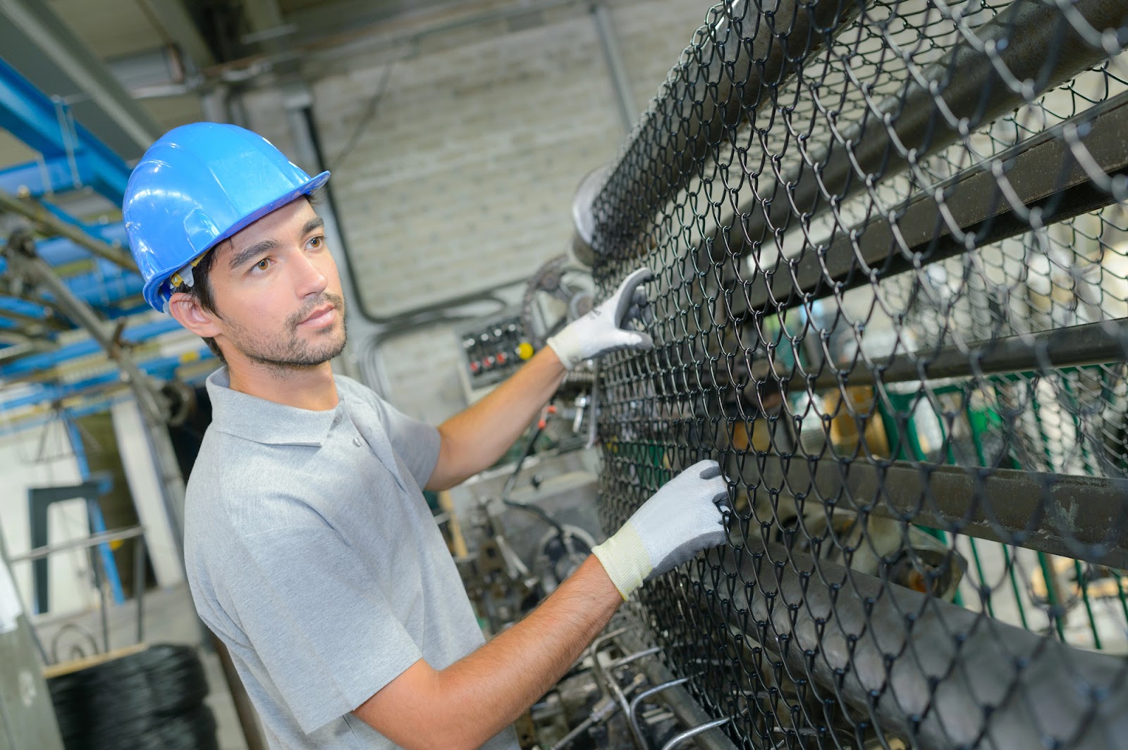 Metal fencing factory and man