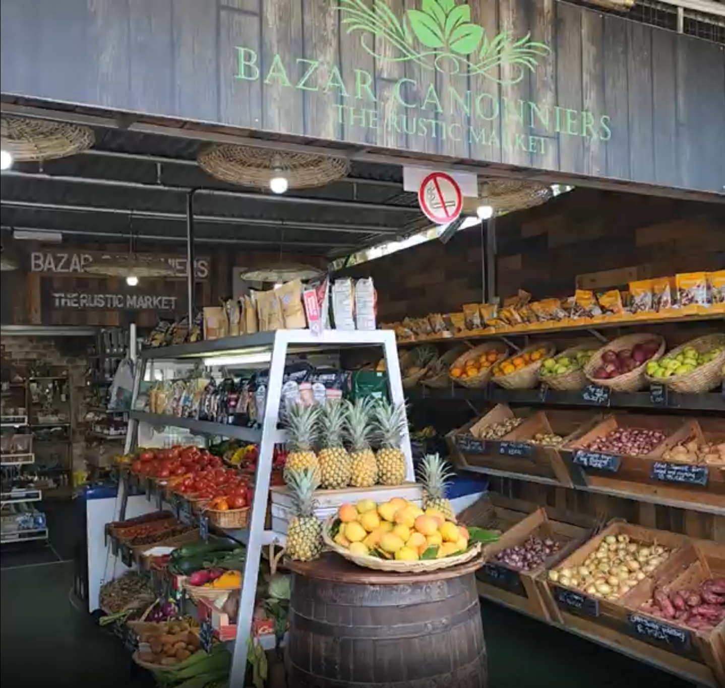 Tropical frut an veggie market with wooden signage