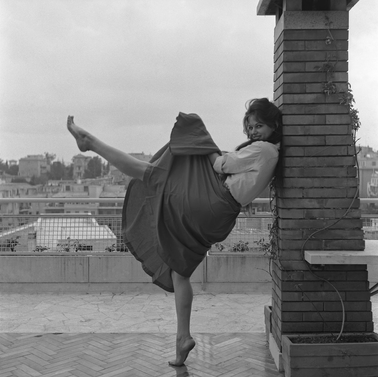 Claudia Cardinale pictured dancing on a terrace on January 1, 1959 in Rome, Italy. | Source: Getty Images