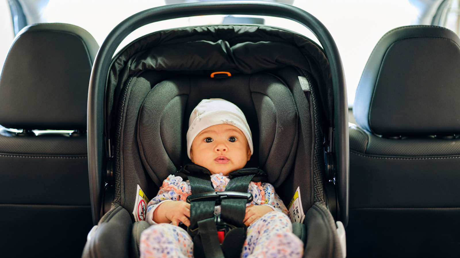 Baby lying in a car seat // Healthier Baby Today