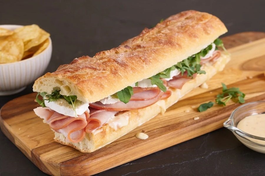 Baguette served with ham, butter, and vegetables