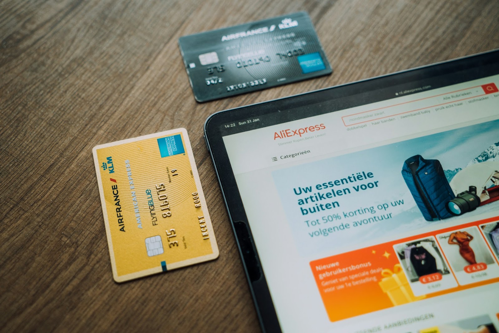 Credit cards beside a tablet symbolizing online shopping and digital transactions.