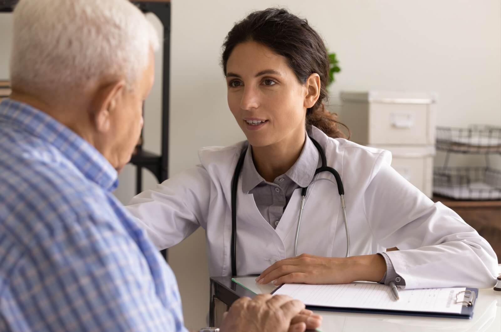 A healthcare professional discussing dementia with an older adult.