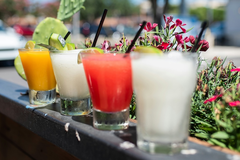 margarita glasses lined up on a ledge