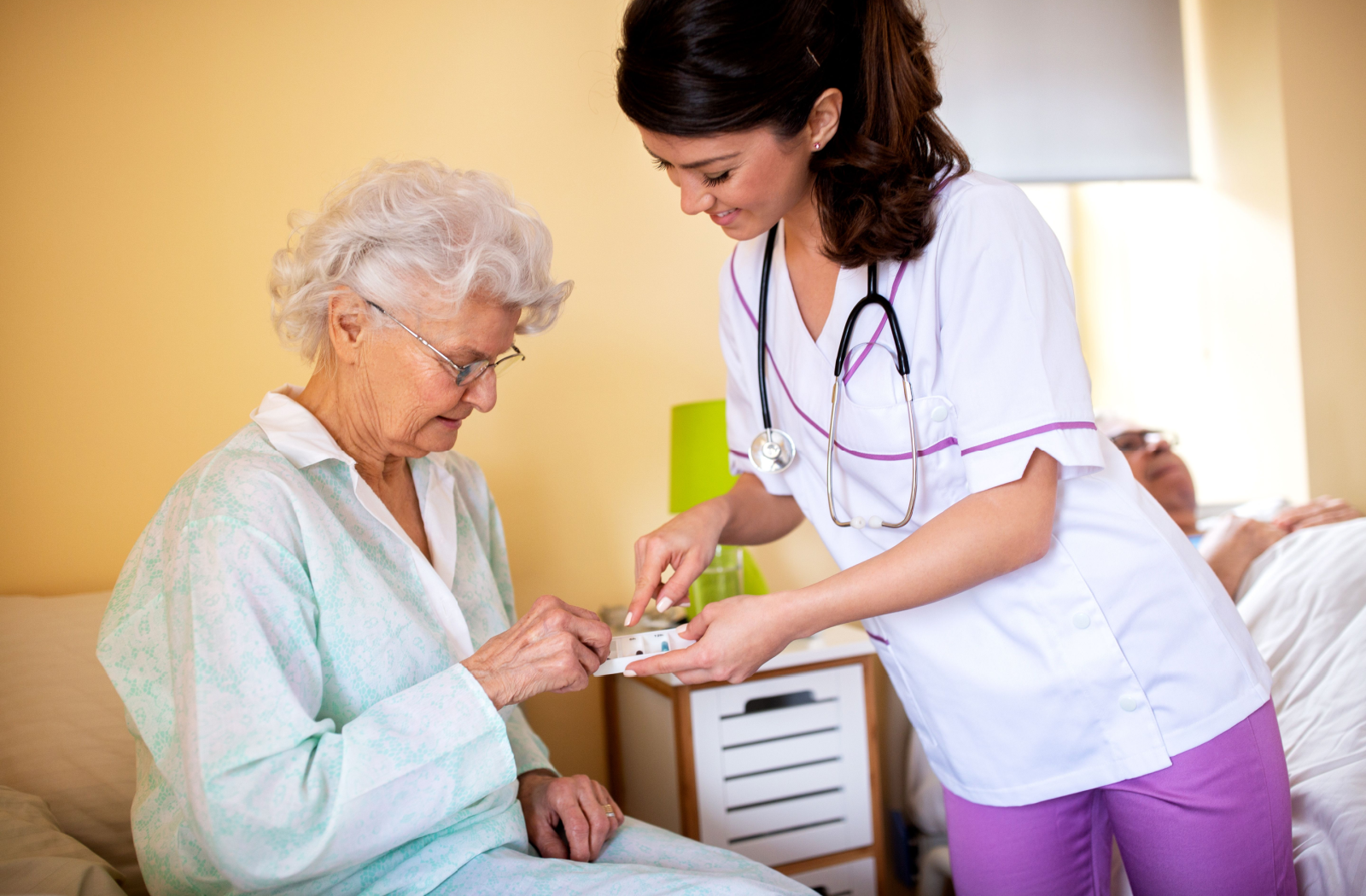 A nurse assisted a senior resident in administering their morning medications.