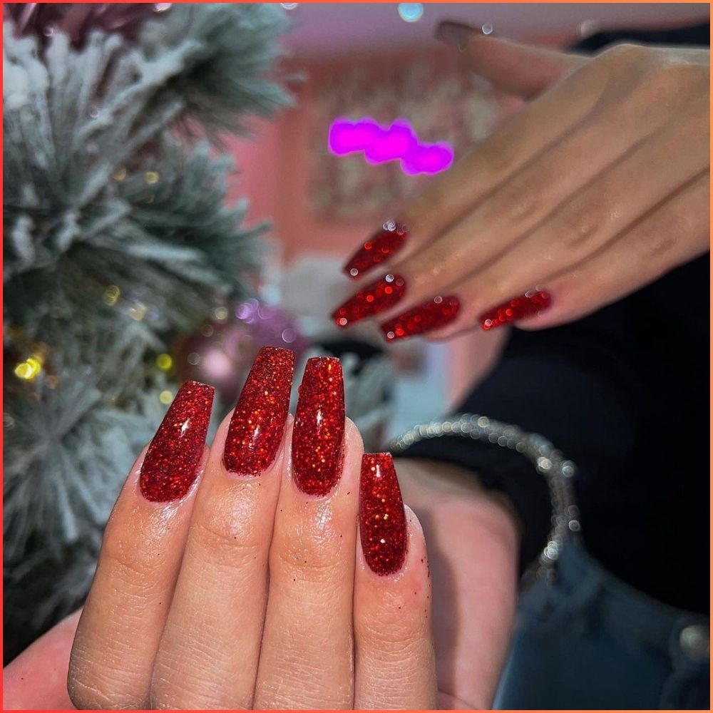 Close up of hands having Christmas red nails with Glittery Red Holiday Sparkle