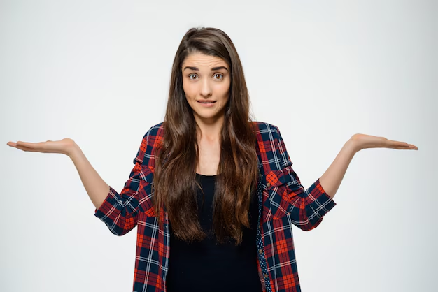 A girl is standing with her hands out in a position of asking a question