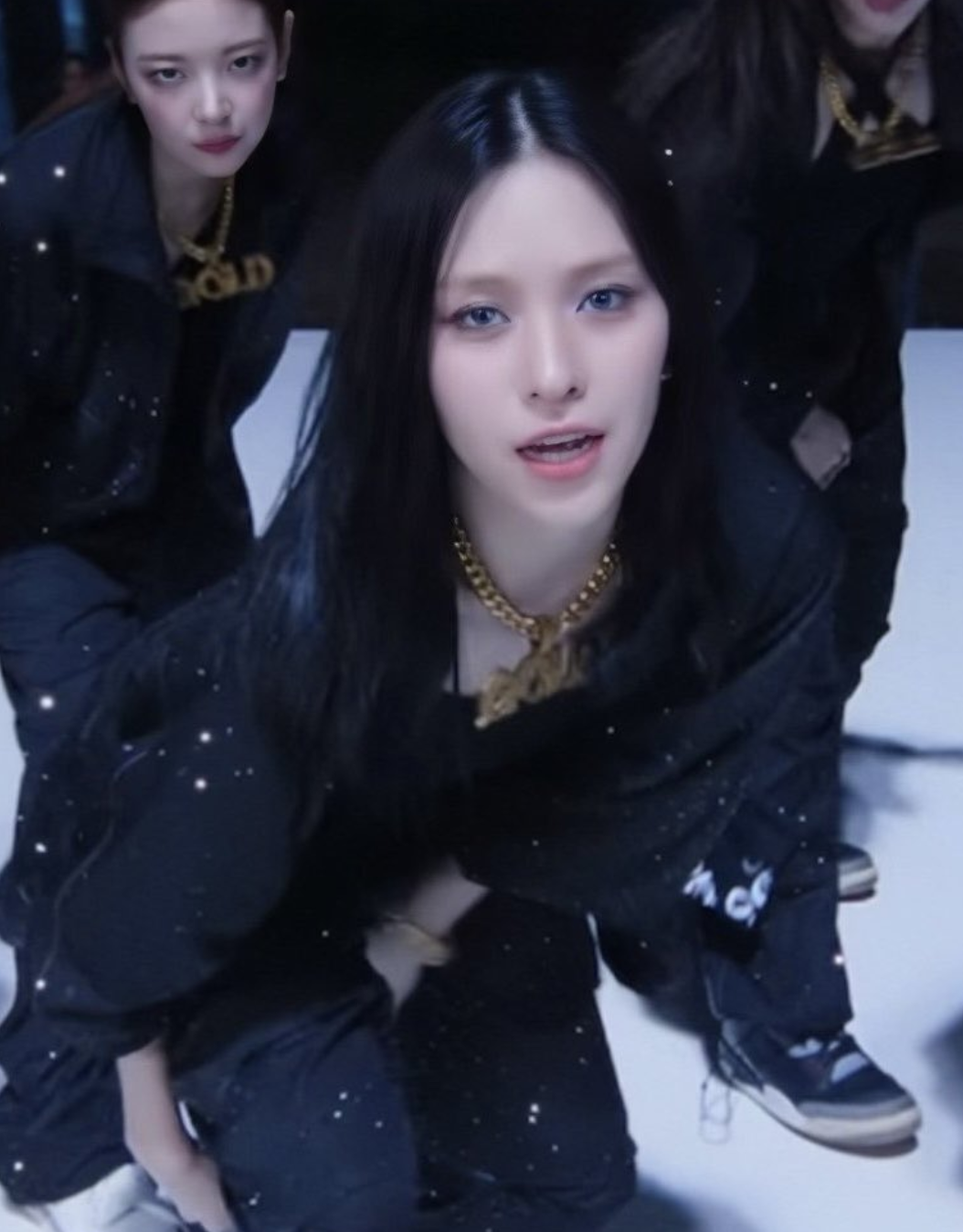 A picture of ITZY Ryujin on black dancing on stage   