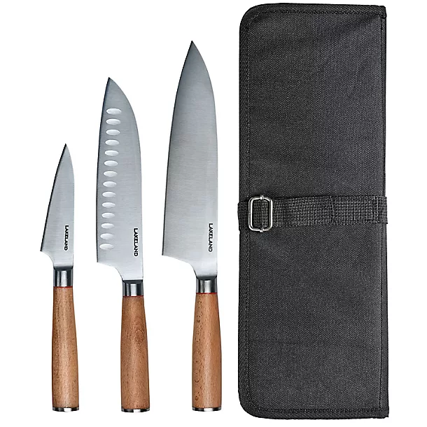 A set of three Lakeland kitchen knives with wooden handles, including a paring knife, Santoku knife, and chef’s knife, displayed alongside a black storage case.