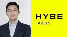 This contain an image  Lee Jae Sang  wearing glasses standing in front of a yellow background with the words hybe labels