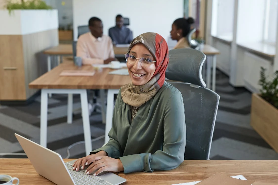 smiling woman sitting on an office chair