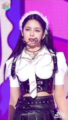 This contains an image of  BLACKPINK Jennie on stage with a black and white cloth