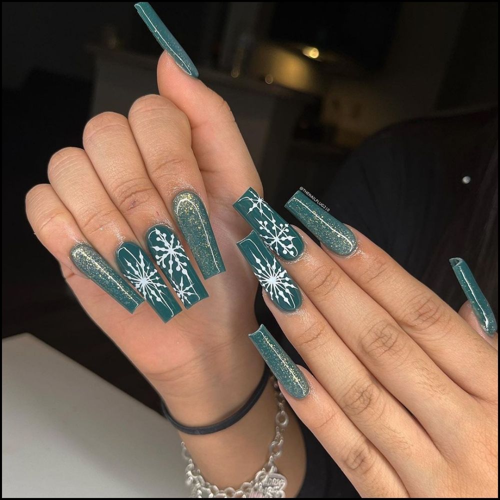 Close up of hands with Christmas Green Nails having Green Glitter Snowflakes