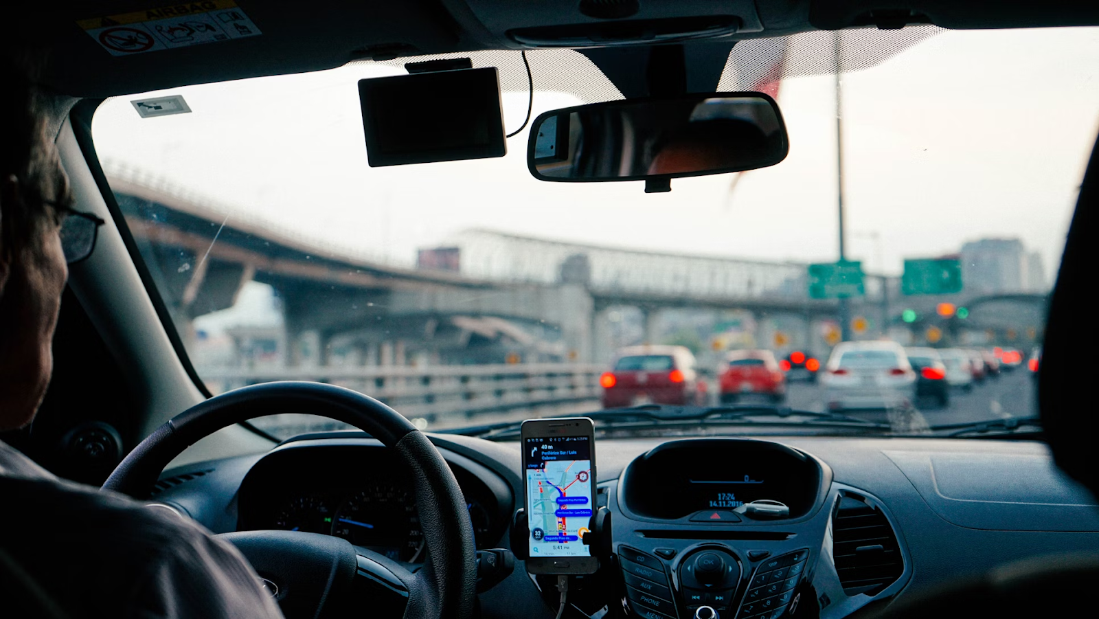 A man sitting in his car during rush hour.