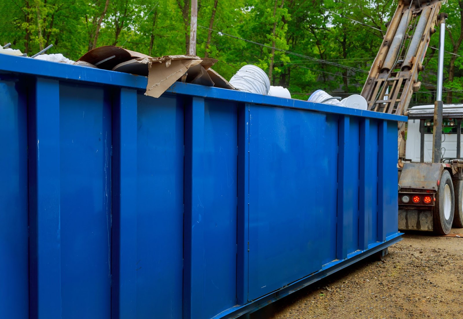 Commercial dumpster being unloaded. 