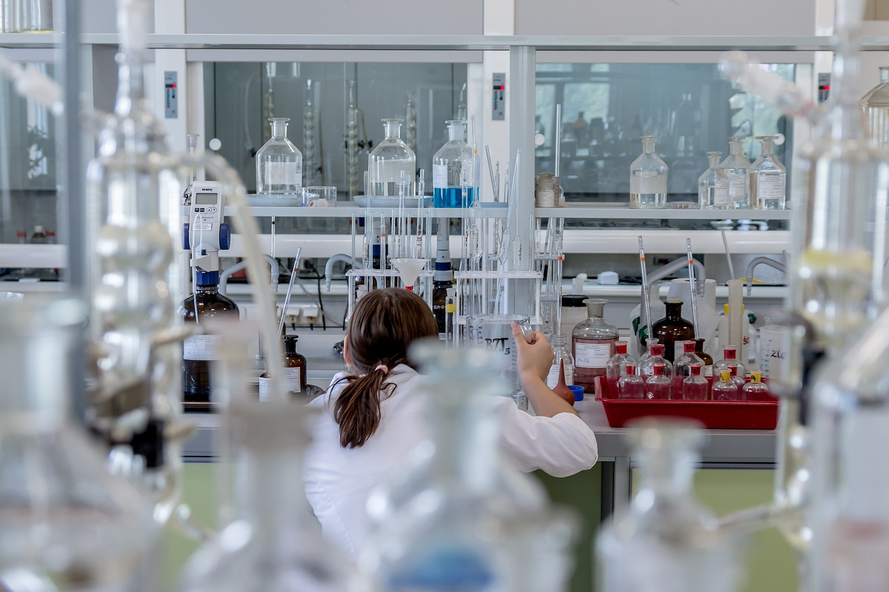 female-scientist-working-in-chemical-laboratory-surrounded-by-glass-bottles-pipettes-and-lab-equipment-inside-the-cartalax-biohacker-stack-real-stacks-for-real-regeneration-tony-huge