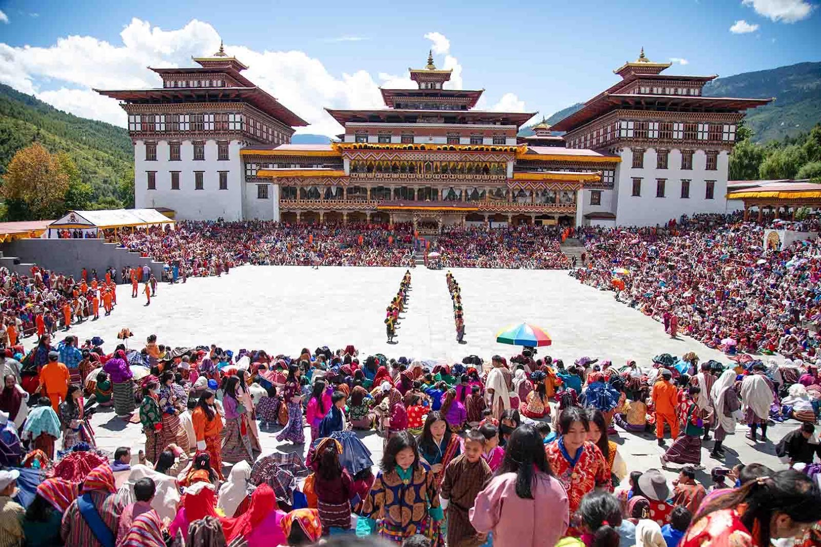 A large crowd of people in front of a buildingDescription automatically generated